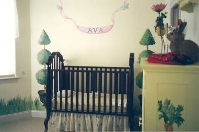 Murals and painted furniture in a baby room
