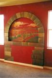Faux stone archway and a wall with red rag roll